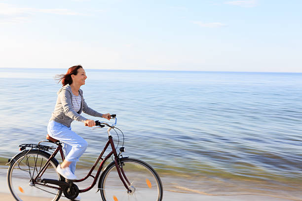 istock Happy mature woman at beach 477525842