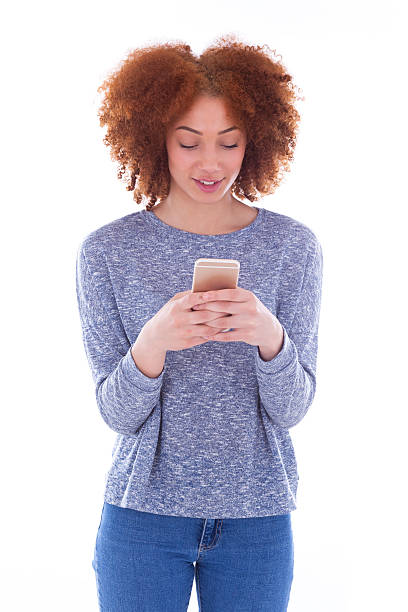 istock African American young woman sending a text message 477528422