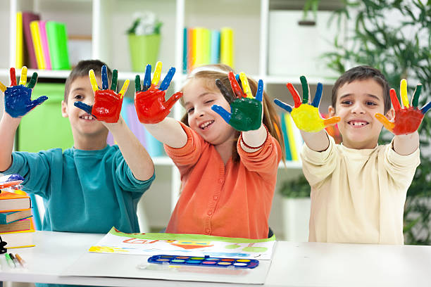 istock Three happy little  kids with painted hands 477529353