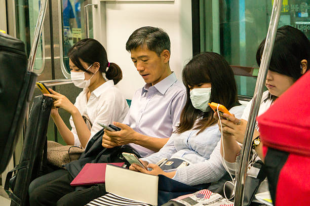 MERS virus outbreak in Korea Seoul, South Korea - June 10, 2015: Commuters on the subway wear masks to protect against the deadly MERS (Middle East Respiratory Syndrome) virus outbreak in Korea. seoul province stock pictures, royalty-free photos & images