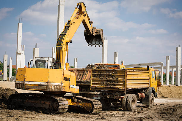 istock Industrial truck loader excavator moving earth and unloading int 477534664