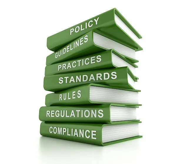 Photo of Stack of green compliance and rules books