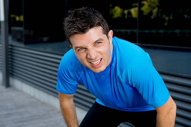 istock young attractive man leaning exhausted after running session sweating 477539636