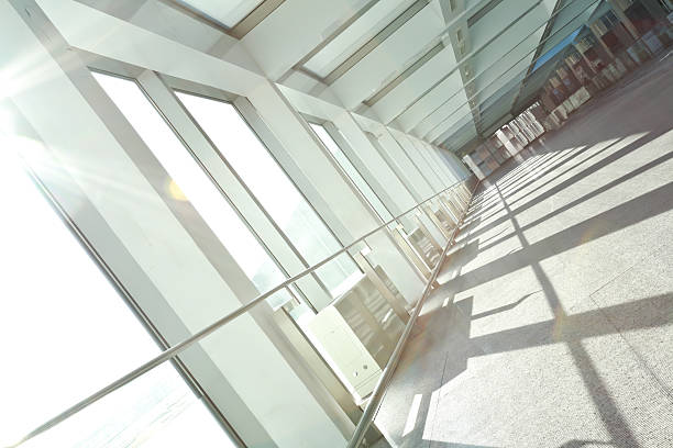 istock Sunny on modern glass office windows building interior corridor 477539652
