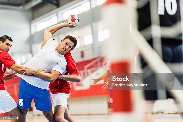 Handball Player Shooting At Goal Stock Photo - Download Image Now - Team Handball, Young Adult, Court Handball