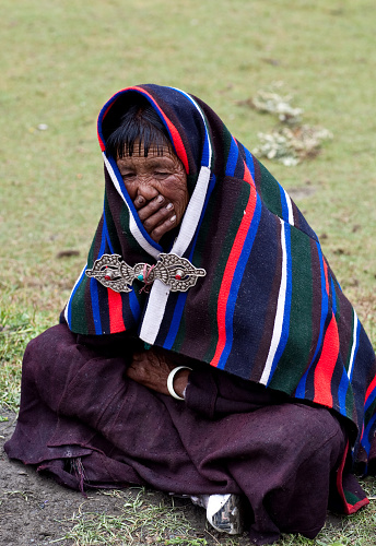 Dolpo, Nepaly - September 11, 2011: Tibetan woman waiting for Puja ceremony during Full Moon Festival.