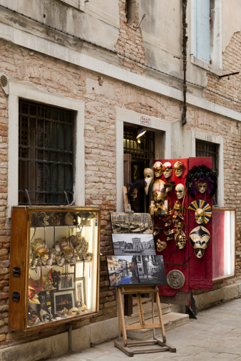 Venice, Italy - May 18, 2012: Gift shop in Venice. There are a lot of such shop in Venice. Tourists can buy masks, postcards, painting or photographs here. 