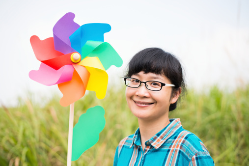 Portrait of happy girl with pinwheel.
