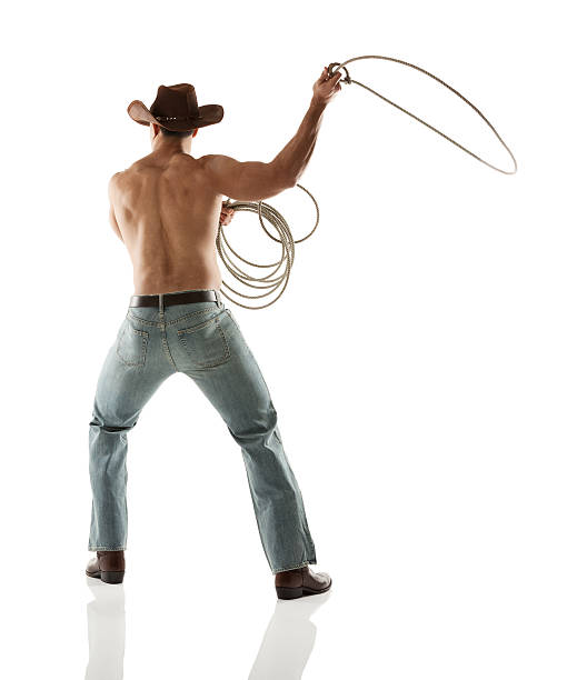 istock Rear view of cowboy swinging a lasso 477545771