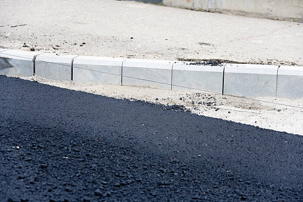 istock Fresh Layer Of Asphalt with Granite Curbs 477546193