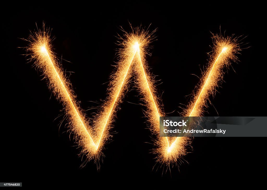 "W" letter drawn with bengali sparkles "W" letter drawn with bengali sparkles isolated on black background 2015 Stock Photo