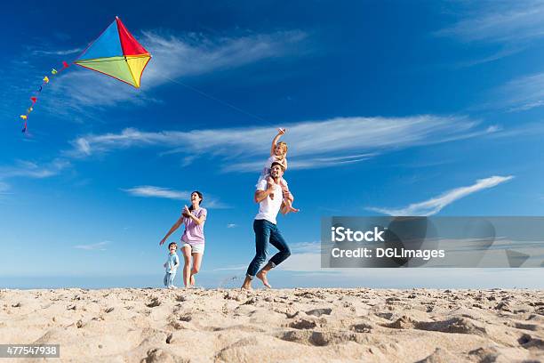 Family On The Beach Flting A Kite Stock Photo - Download Image Now - Family, Beach, Kite - Toy