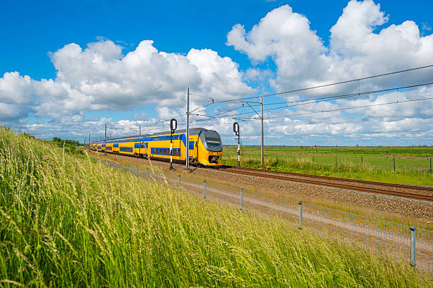 Electric train driving through nature in spring Electric train driving through nature in spring almere photos stock pictures, royalty-free photos & images