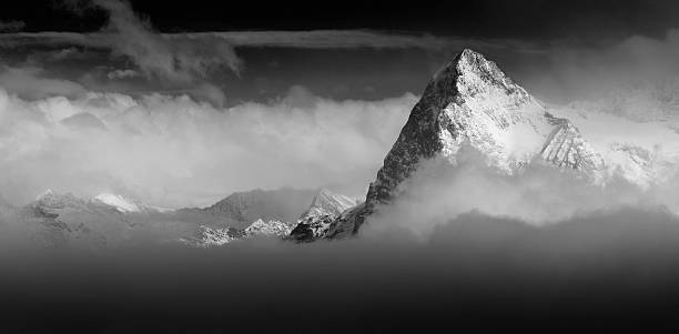 la parete nord dell'eiger in svizzera alpi erge sopra le nuvole - european alps switzerland glacier high angle view foto e immagini stock