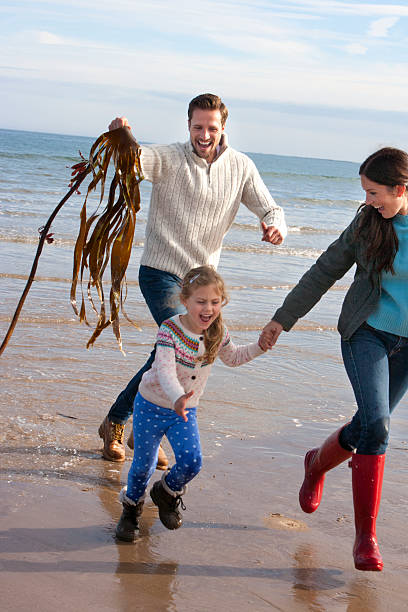 istock Family on Beach with Seaweed 477548400