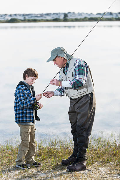 istock Boy fishing with grandfather 477548571
