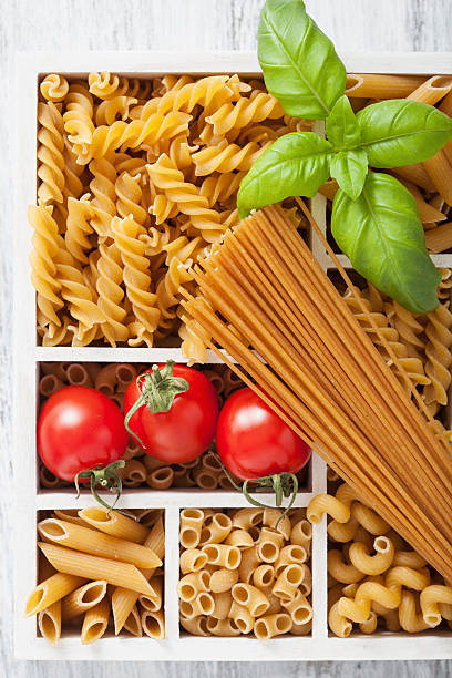 istock various raw wholegrain pasta in white wooden box 477549008