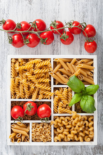 istock various raw wholegrain pasta in white wooden box 477549026