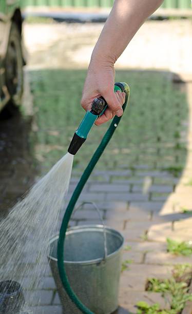 istock male hand washes the car with a hose 477549094