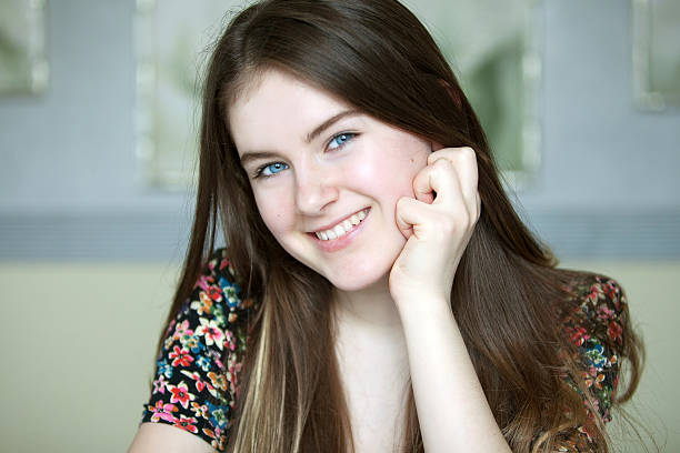 Beautiful teenager girl with long hair and blue eyes. stock photo