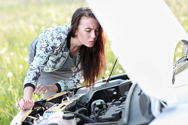 istock attractive brunette in front of her car 477549340