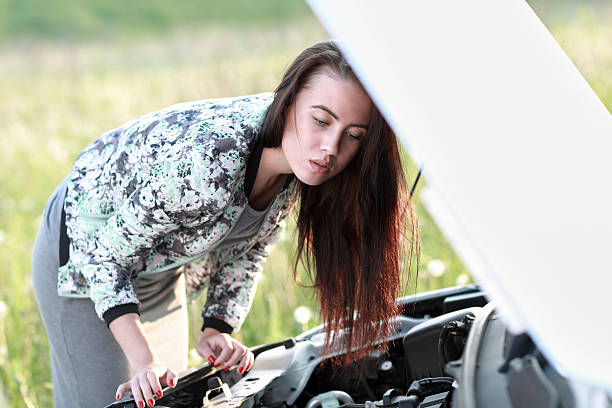 istock attractive brunette in front of her car 477549360