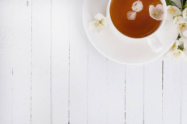 istock cup of green tea with jasmine on a white surface 477549944