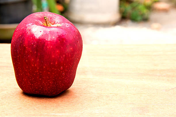 istock Ripe red apples on wooden background 477550068