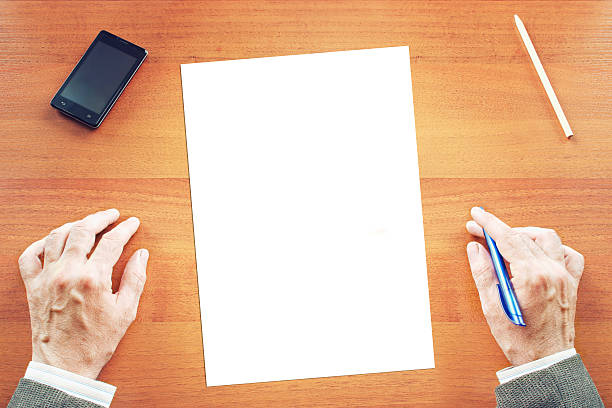 istock Paper sheet on a desk and man ready to write 477550134