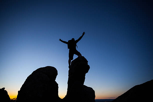 istock silhouette man sunset on top of the world 477550169