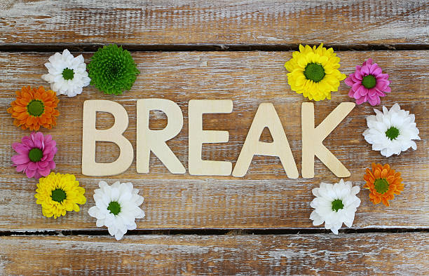 istock Break written with wooden letters and Santini flowers 477550342