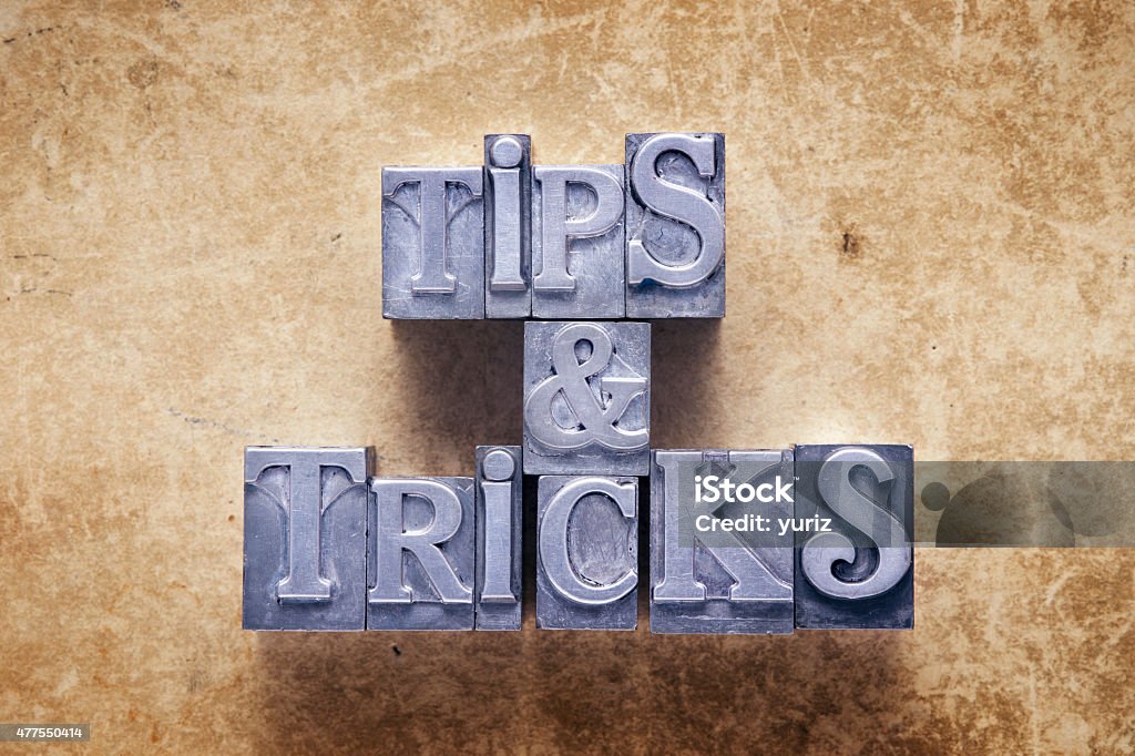 tips and tricks tips and tricks label made from metallic letterpress type on vintage cardboard Magic Trick Stock Photo