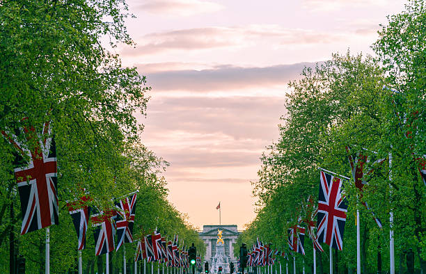 The Mall flags Lines of union jack flags hanging along the Mall, London buckingham palace photos stock pictures, royalty-free photos & images