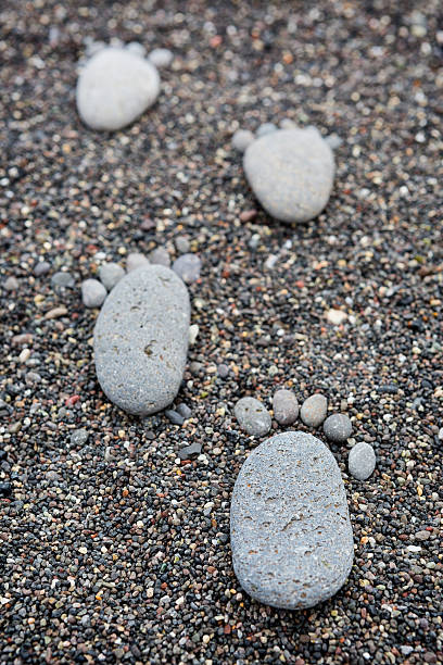 istock Footprint on wet sea pebbles 477555524