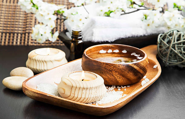 istock Candle and Water Bowl with Flowers Blossom Spa Setting.Wellness 477556956