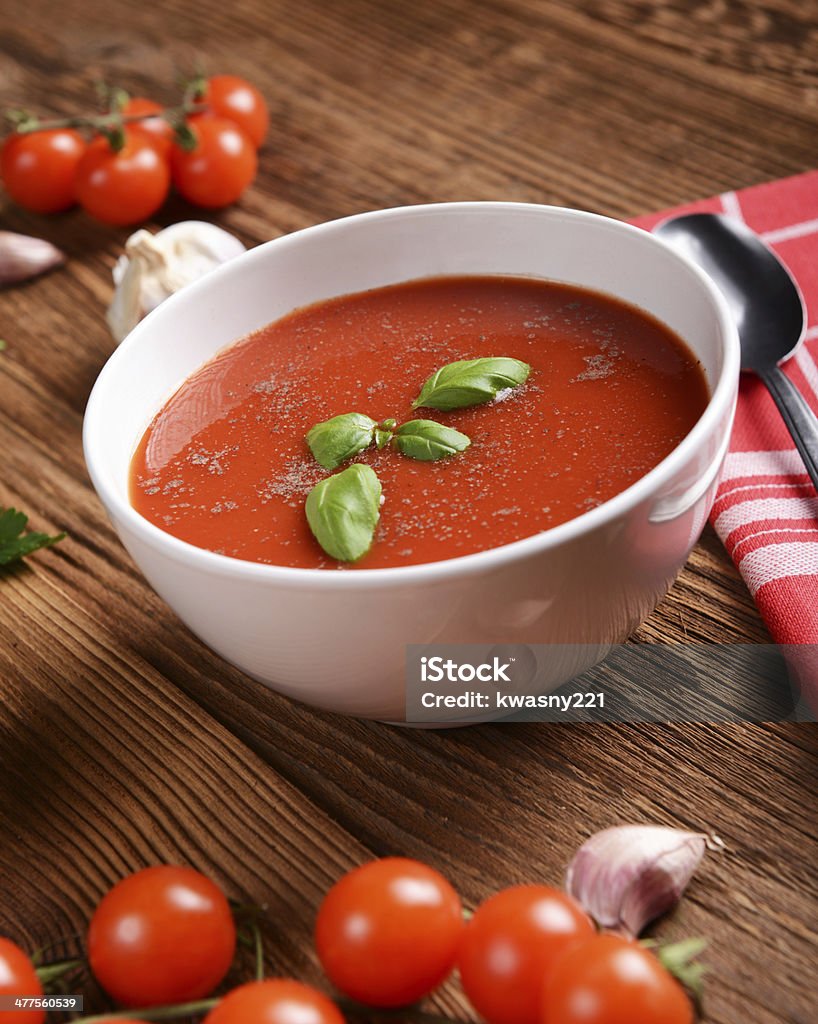 Tomato soup Tasty tomato soup on wooden background Tomato Soup Stock Photo