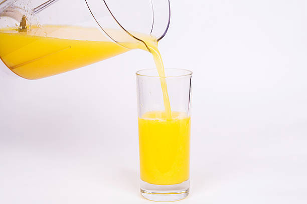 istock pouring orange juice into a glass 477560728