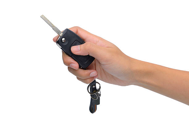 istock Hand with a car key. Isolated on white background. 477561039