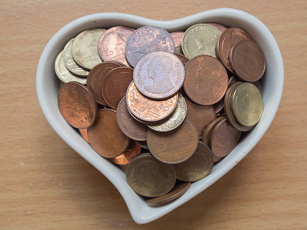 istock Baht coins in the heart shape cup. 477562066