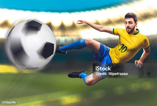 Brazilian Soccer Player Kicks The Ball On Stadium Stock Photo - Download Image Now - 2014, Aspirations, Blue
