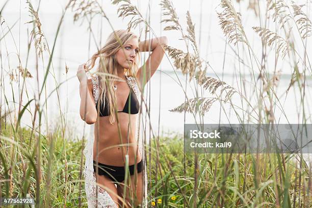 Beautiful Young Woman On Sand Dunes At The Beach Stock Photo - Download Image Now - 20-29 Years, 2015, Adult