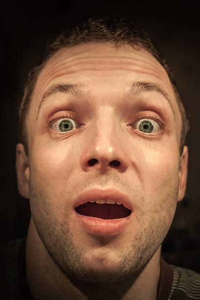 istock Young shocked Caucasian man portrait on dark background 477564945