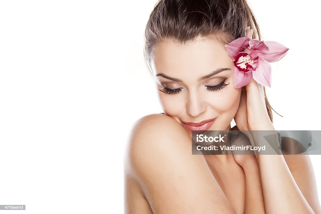 Pure Beauty beautiful young woman posing with orchid Flower Stock Photo