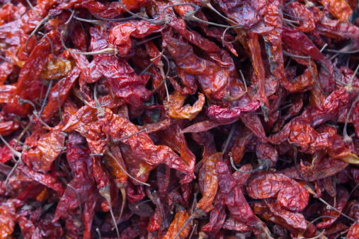 Drying red hot chili peppers at Chichicastenango market in Guatemala