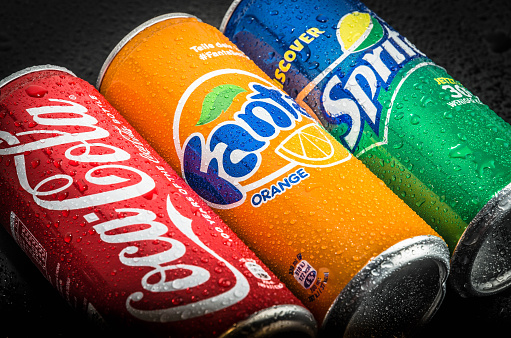 Leonding, Austria - June 16, 2015: A can of Coca Cola, Sprite and Fanta on black background covered with waterdrops. It is produced by The Coca-Cola Company of Atlanta, Georgia.