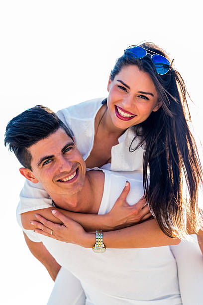 istock Cheerful handsome man carrying his girlfriend piggyback 477567844
