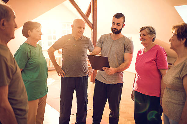 istock Young coach making an exercise plan for group of seniors. 477567980