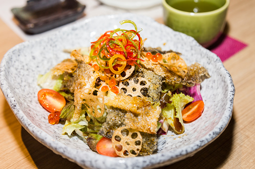 Japanese shake kawa salad with dried salmon skin and lotus roots