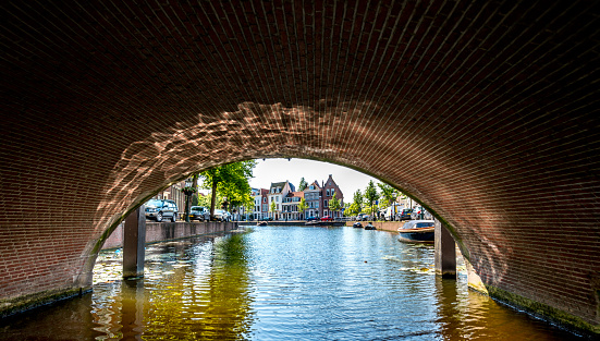 Shot from the water, under a bridge view on the Rapenburg