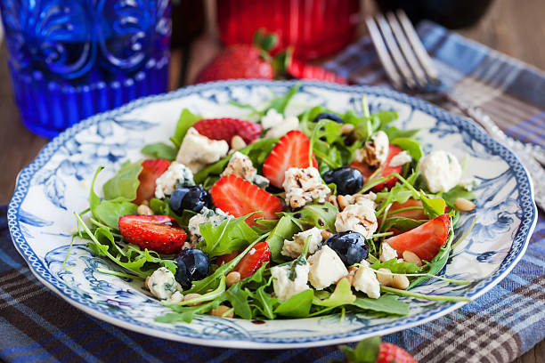 istock Arugula, strawberry, blueberry and blue cheese salad 477569864